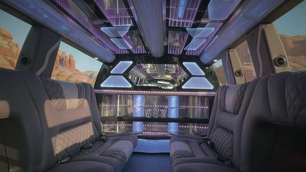 Inside the Cadillac Escalade limo in Fort Collins: LED light-show ceiling, leather lounge seating and lit bar